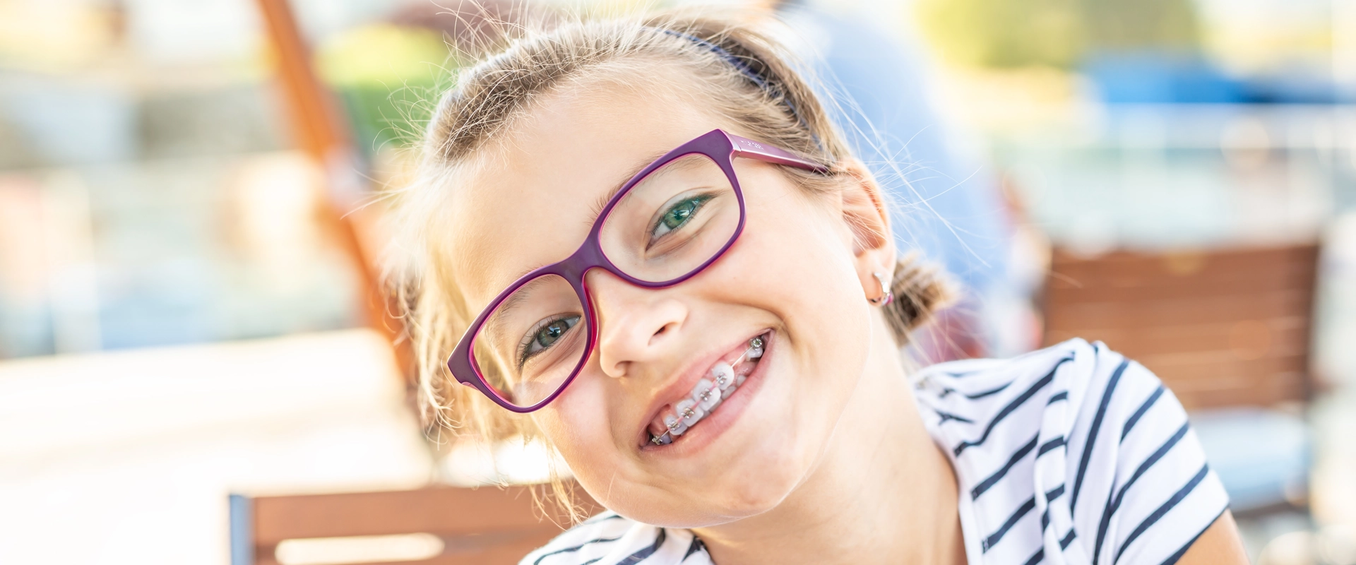 young girl with glasses and braces smiling